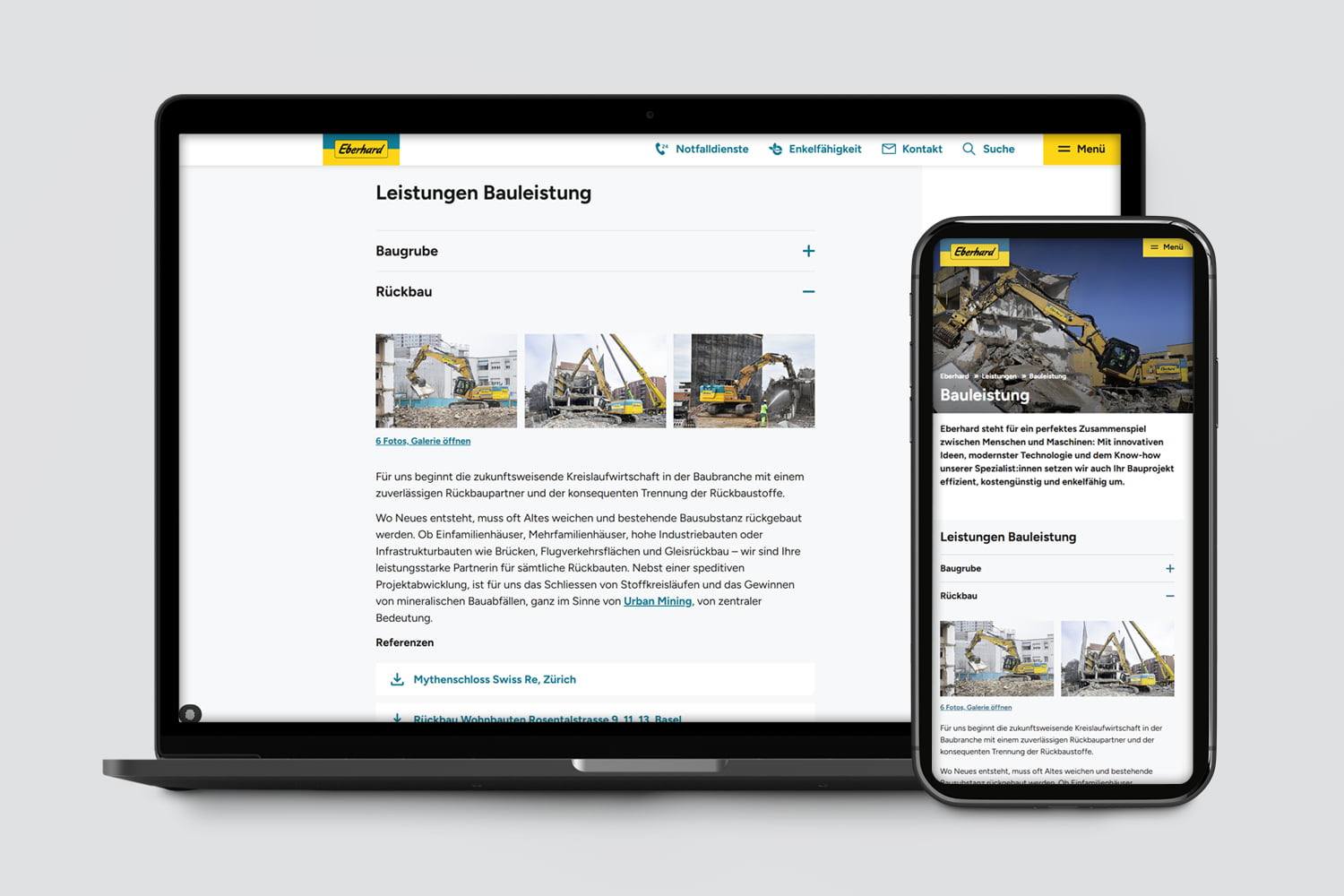 Laptop und Smartphone zeigen Website mit Abrissarbeiten und Baustellen-Fotos
